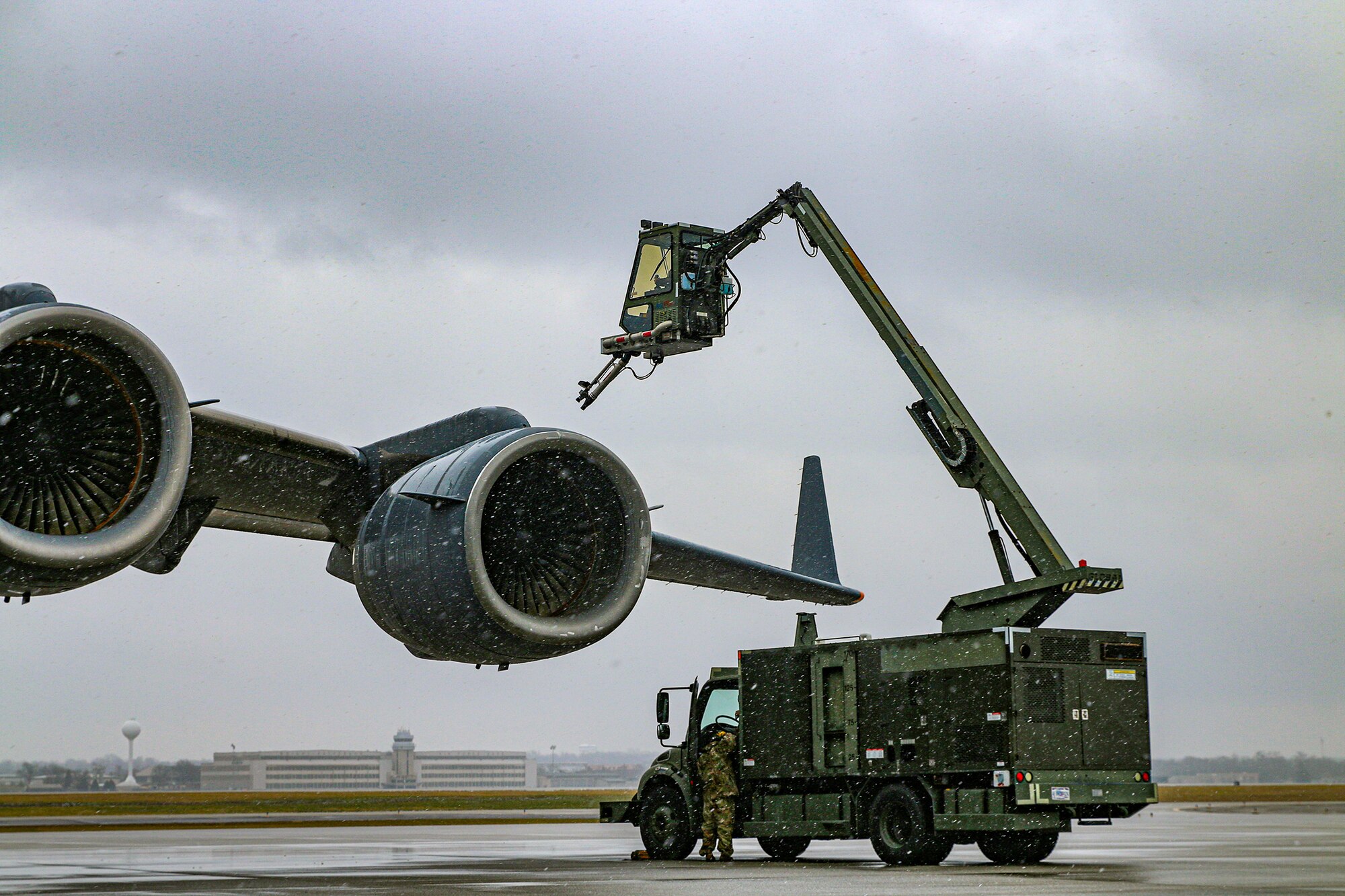 Airmen from the 445th Aircraft Maintenance Squadron de-ice a C-17 Globemaster III before taking off for a local training mission at Wright-Patterson Air Force Base, Ohio Jan. 7, 2024. The Airmen spray the entire aircraft with Glycol. The GL-1800 de-icing trucks maneuver carefully around the aircraft to ensure the entire aircraft is spayed. They repeat the process twice to ensure no ice is left on the aircraft and that none has formed overtime before takeoff.