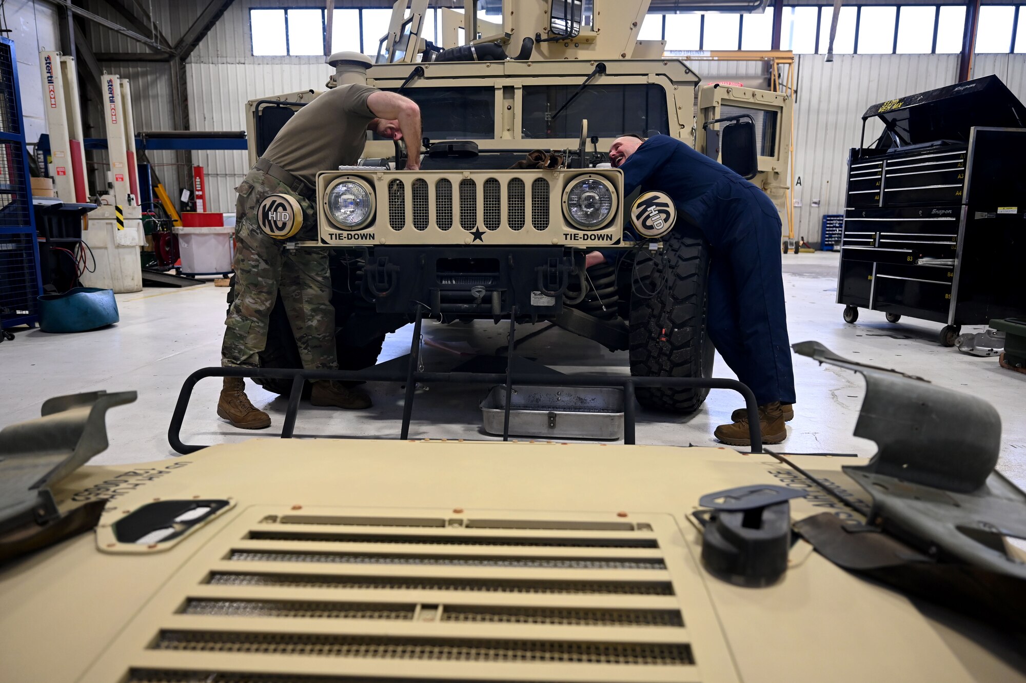 Sergeants work on engine