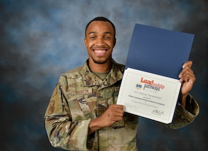 Man poses with a certificate