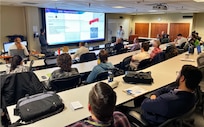 Employees of Naval Undersea Warfare Center Division, Keyport participate in a Technical Talk recently held at the command as part of a partnership between its Undersea Weapons Department and the Naval Postgraduate School.