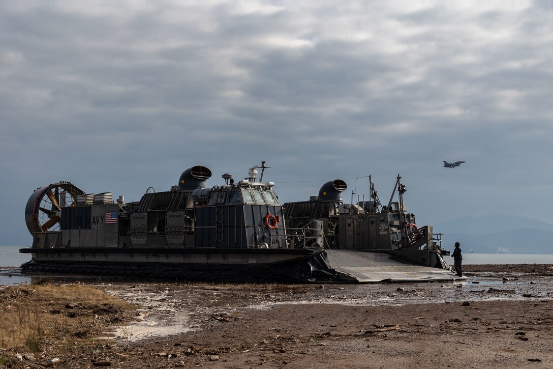 A U.S. Navy Landing Craft Air Cushion (LCAC) lands on the beach prior to returning to the San Antonio-class amphibious transport docking ship USS Mesa Verde (LPD 19) with Marines from the 26th Marine Expeditionary Unit (Special Operations Capable), Lido Beach, Greece, Jan. 11, 2024. The 26th MEU(SOC) readiness sustainment exercise enhances the unit’s operational capabilities as an expeditionary crisis response force and provides an opportunity for the 26MEU(SOC) to conduct advanced integrated expeditionary operations and live-fire training with both the 32nd Marine Brigade and the 24th Armored Brigade in Greece. The Bataan Amphibious Ready Group, with the embarked 26th Marine Expeditionary Unit (Special Operations Capable), is on a scheduled deployment in the U.S. Naval Forces Europe area of operations, employed by U.S. Sixth Fleet to defend U.S., Allied and partner interests.  (U.S. Marine Corps photo by Cpl. Michele Clarke) (U.S. Marine Corps photo by Cpl. Michele Clarke)