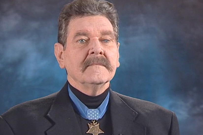 A person wears a Medal of Honor in a screenshot of an interview.