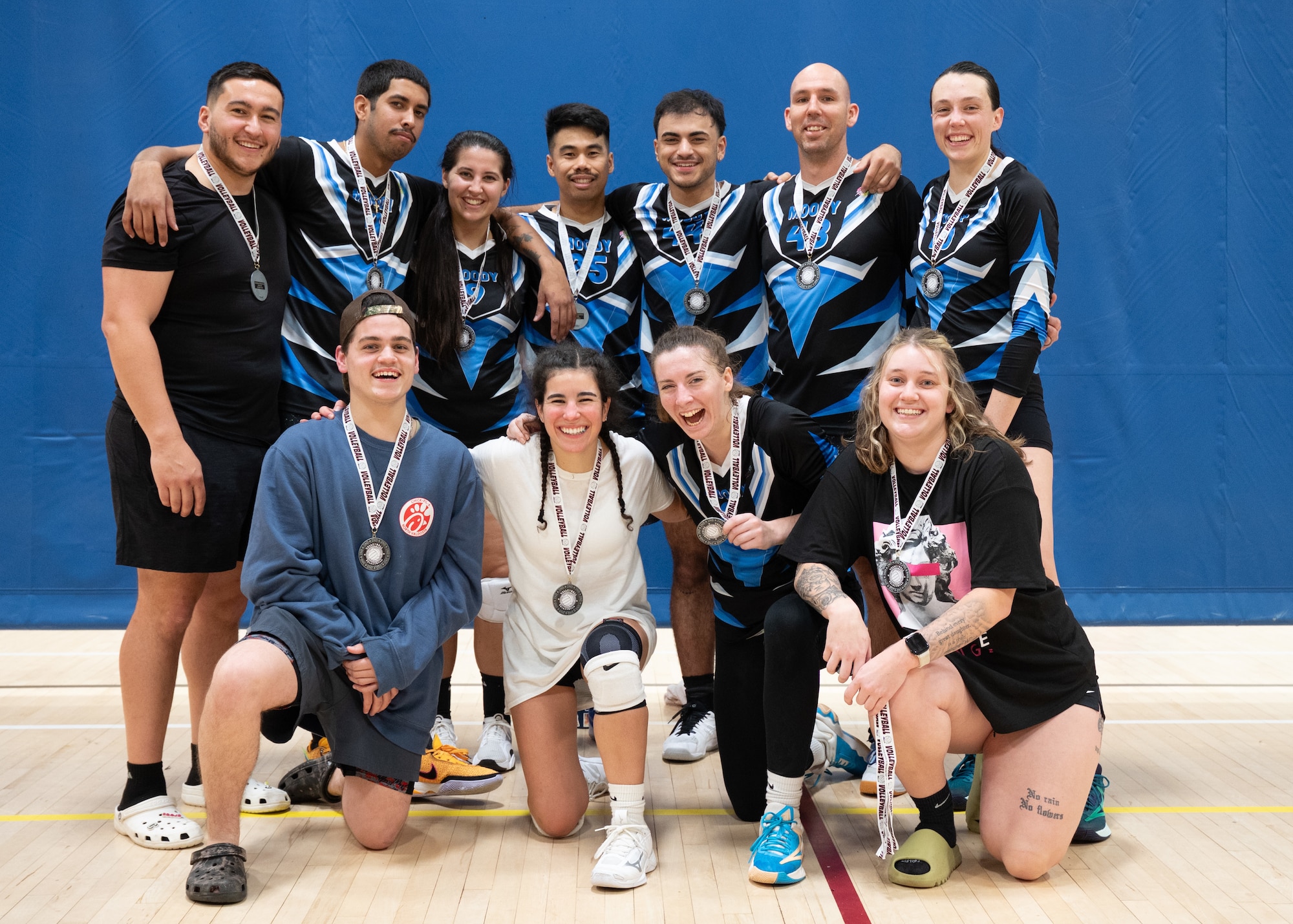 A volleyball team poses for a photo after placing second in a tournament