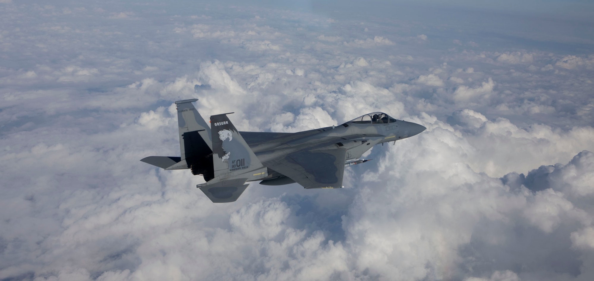 The iconic Kingsley Field eagle tail flash is seen flying high above the clouds for all to see on the U.S. Air Force F-15C assigned to the 173rd Fighter Wing.