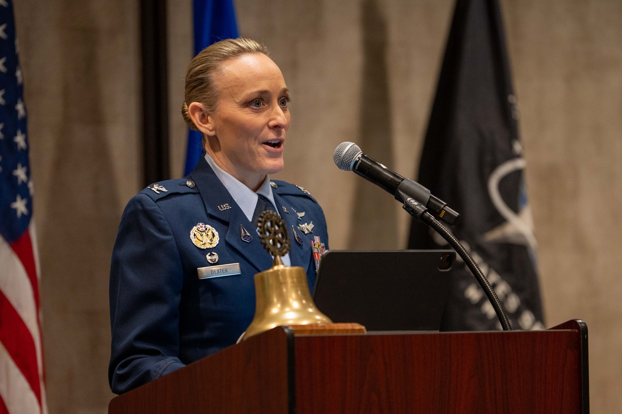 Space base leader speaks at podium.