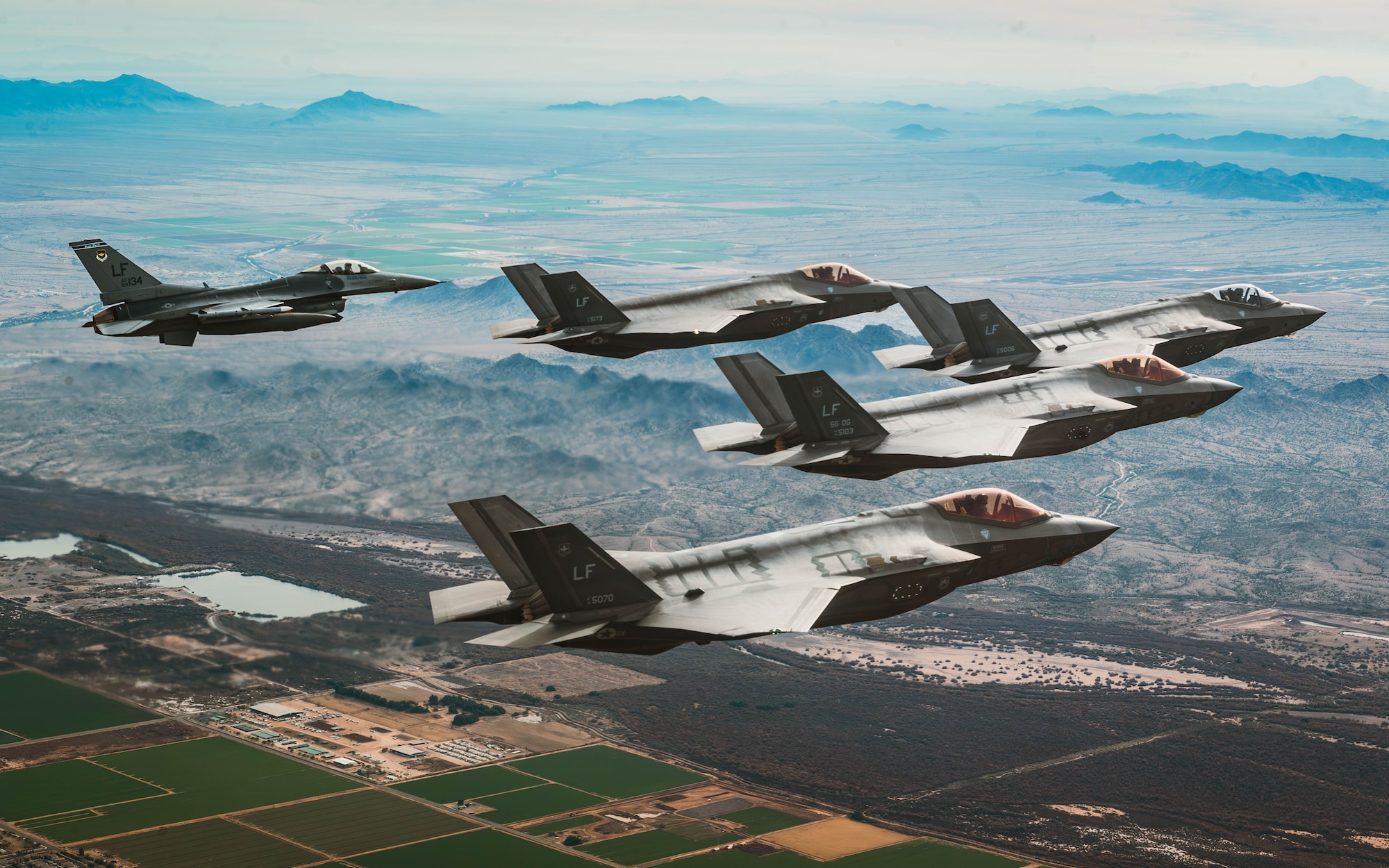 U.S. Air Force F-35A Lightning II’s assigned to the 61st Fighter Squadron and an F-16 Fighting Falcon aircraft assigned to the 309th Fighter Squadron, fly in formation, Jan. 19, 2024, over Luke Air Force Base, Arizona.
