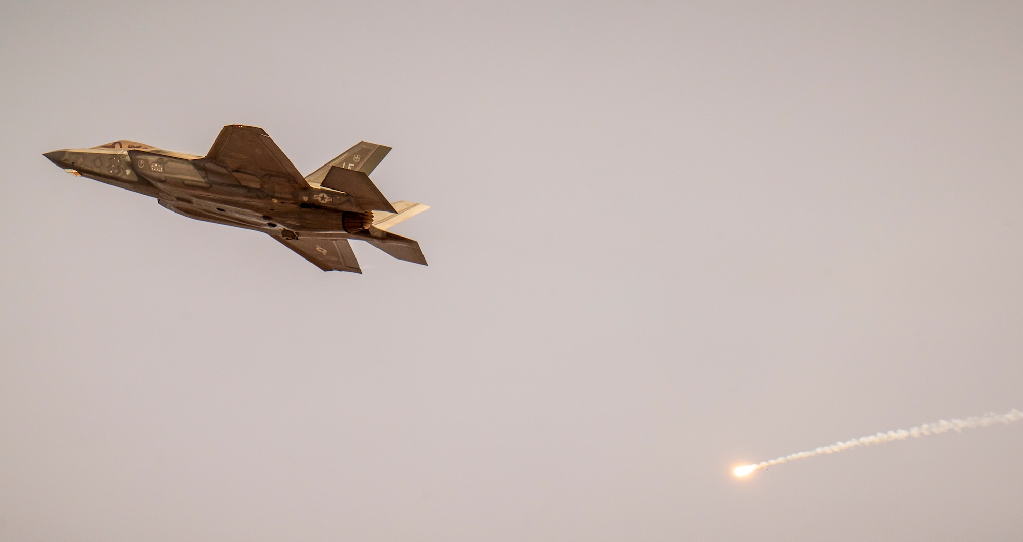 An F-35 Lightning II assigned to the 61st Fighter Squadron, Luke Air Force Base, Arizona, fires a flare over Barry M. Goldwater Range, Arizona, Jan. 19, 2024.