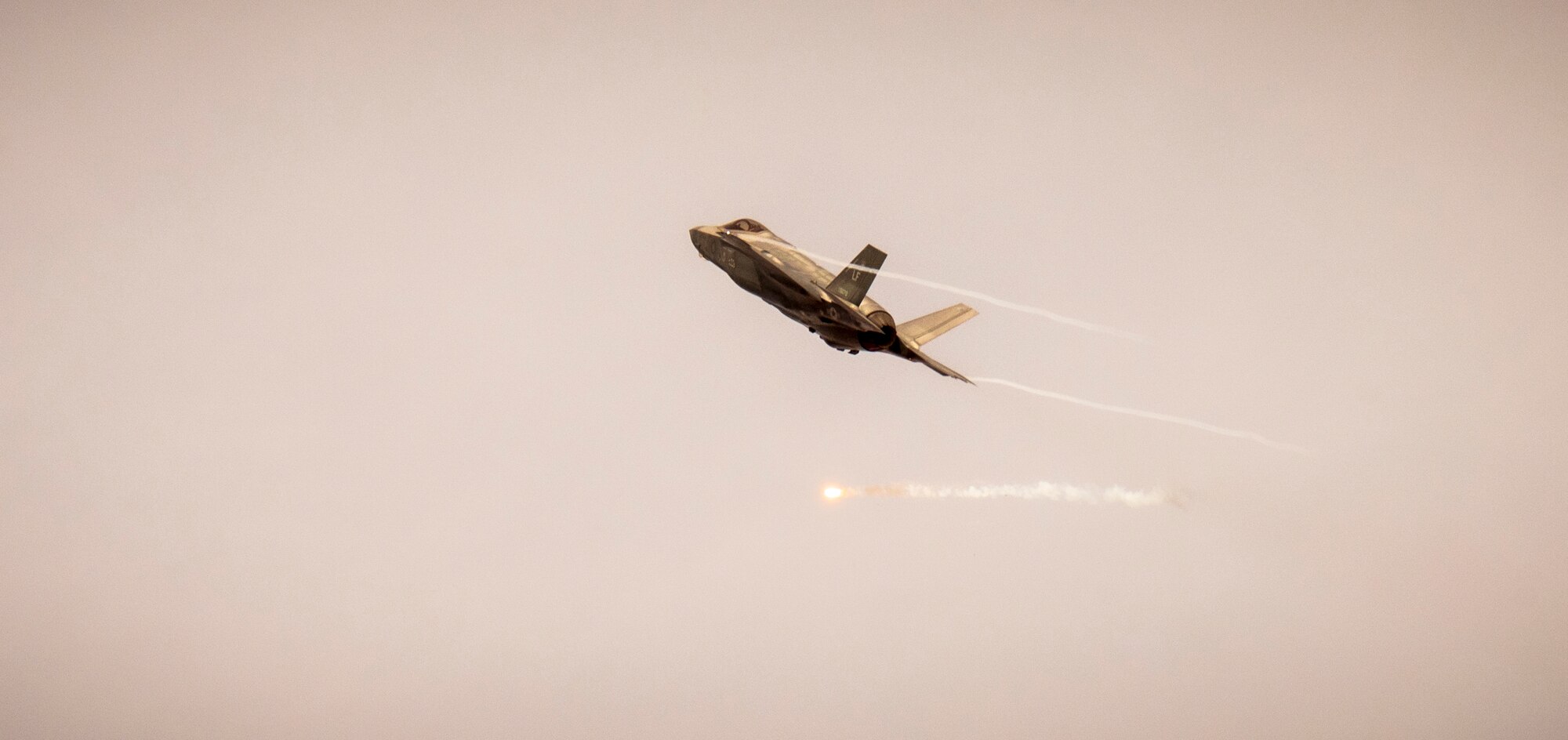 An F-35 Lightning II assigned to the 61st Fighter Squadron, Luke Air Force Base, Arizona, fires a flare over Barry M. Goldwater Range, Arizona, Jan. 19, 2024.