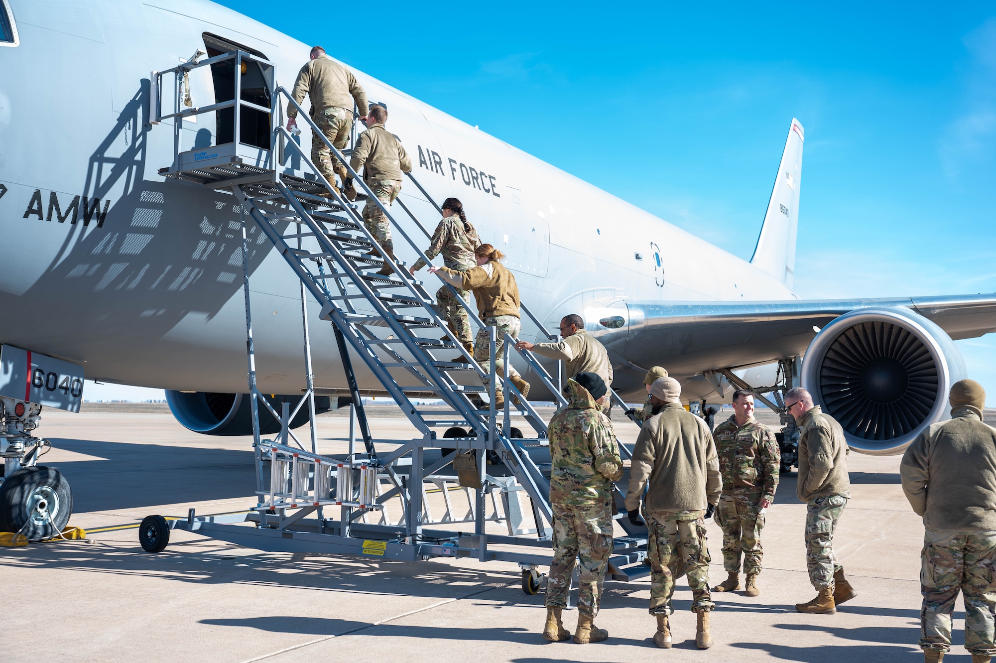 Chapel members from Altus, Sheppard, and Vance Air Force Base enter a KC-46A Pegasus aircraft at Altus Air Force Base, Oklahoma, Jan. 19, 2024. The group toured the static display and witnessed the mission at the 97th Air Mobility Wing. (U.S. Air Force photo by Airman First Class Heidi Bucins)