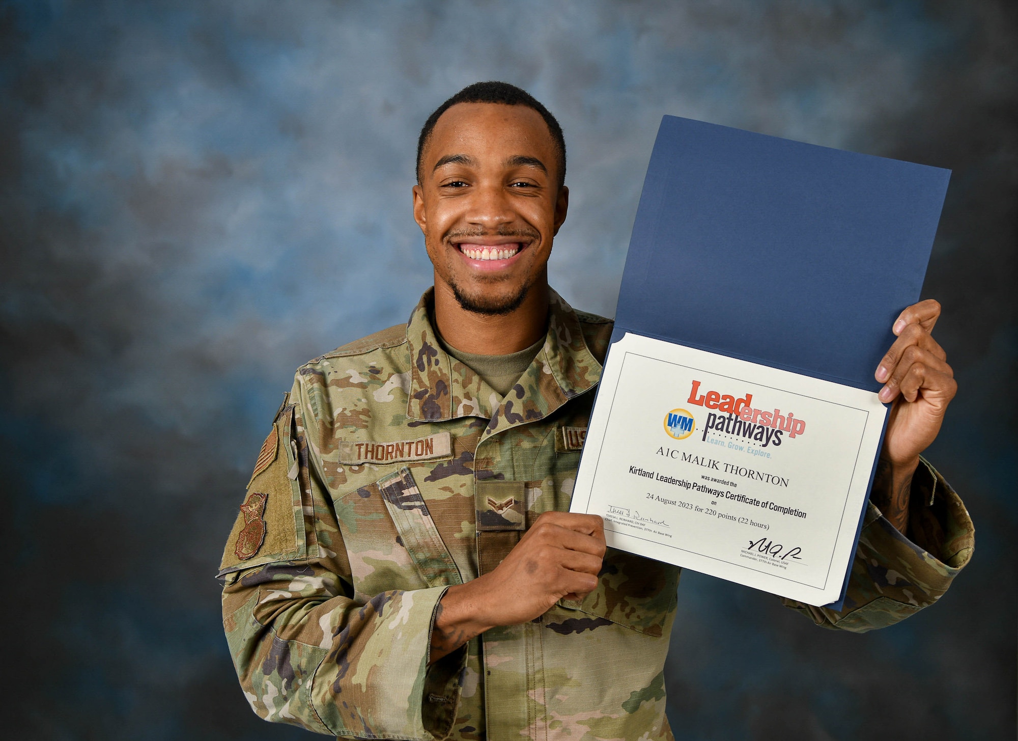 Man poses with a certificate