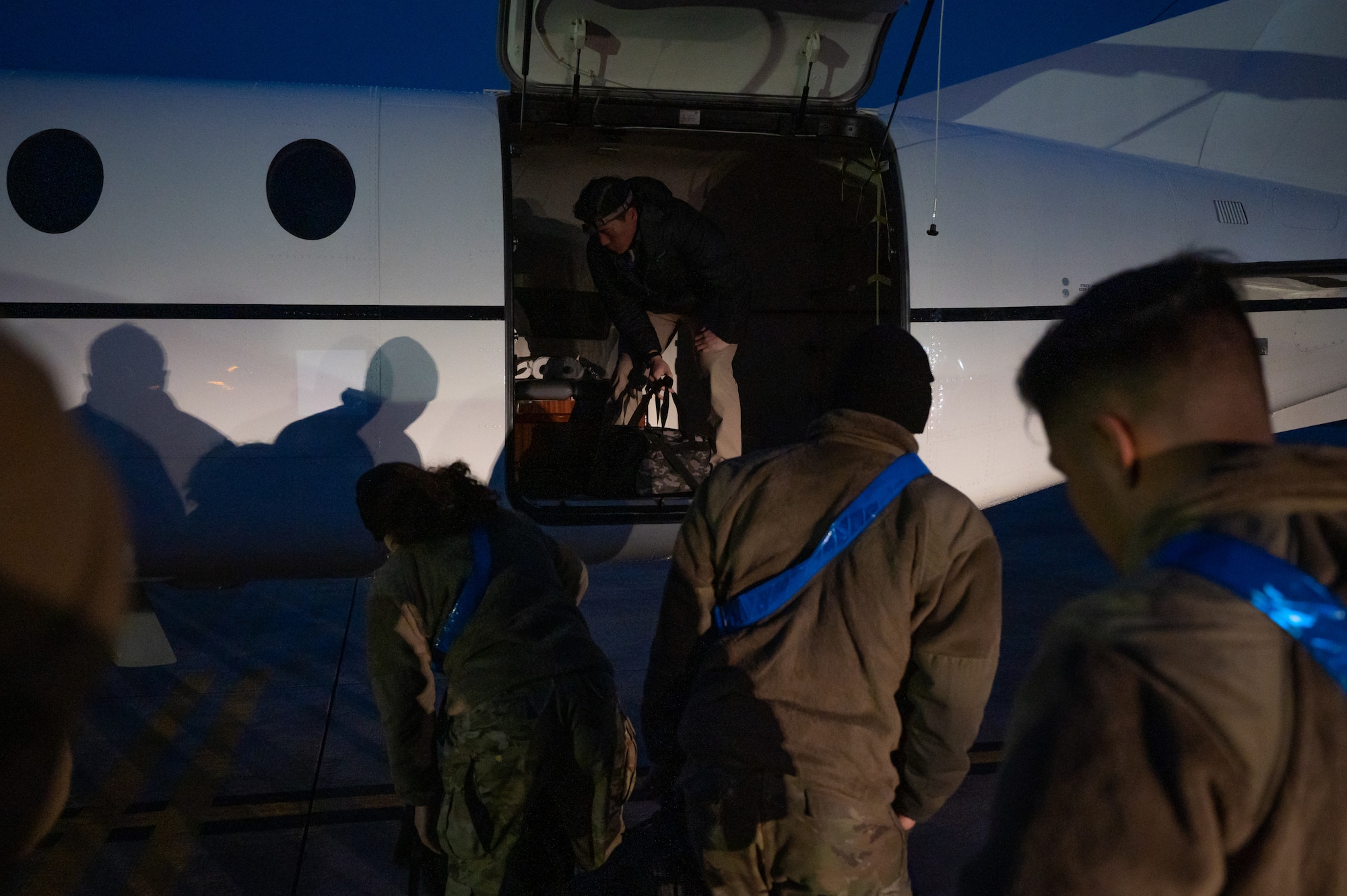 35th Fighter Generation Squadron members load cargo into an MC-12 Liberty.