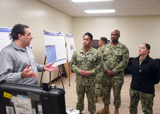 JOINT BASE SAN ANTONIO-FORT SAM HOUSTON – (Jan. 24, 2024) – Dr. William D’Angelo, a biomedical engineer assigned to the Biomedical Systems Engineering and Evaluation Department, Naval Medical Research Unit (NAMRU) San Antonio, briefs Force Master Chief PatrickPaul Mangaran, director, Hospital Corps, U.S. Navy Bureau of Medicine and Surgery (BUMED) and Master Chiefs Hospital Corpsman Hansen LaFoucade, deputy director, Hospital Corps, and Leslie Giuy, lead hospital corpsman planner on a prototype portable ozone sterilizer at the Tri-Service Research Laboratory.  The equipment is being developed by NAMRU San Antonio to be utilized by front-line military corpsmen, clinicians, and dentists during combat and humanitarian missions.  NAMRU San Antonio’s mission is to conduct gap driven combat casualty care, craniofacial, and directed energy research to improve survival, operational readiness, and safety of Department of Defense (DoD) personnel engaged in routine and expeditionary operations. It is one of the leading research and development laboratories for the U.S. Navy under the DoD and is one of eight subordinate research commands in the global network of laboratories operating under the Naval Medical Research Command in Silver Spring, Md. (U.S. Navy photo by Burrell Parmer, NMFSC Public Affairs/Released)