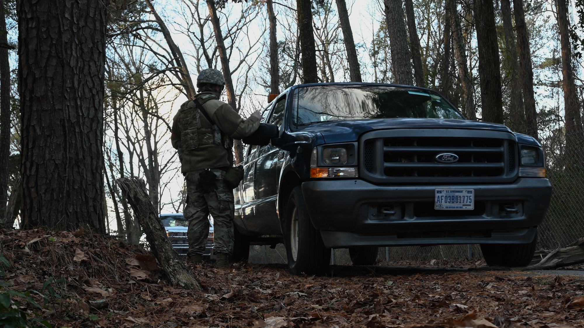 A U.S. Airman assigned to the 4th Civil Engineer Squadron conducts a vehicle checkpoint during a bivouac field training exercise at Seymour Johnson Air Force Base, North Carolina, Jan. 18, 2024. The bivouac training tested the squadron's ability to secure and establish base operations infrastructure within a timely manner and conduct contingency and wartime operations if the opportunity were to arise. (U.S. Air Force Photo by Airman Rebecca Tierney)
