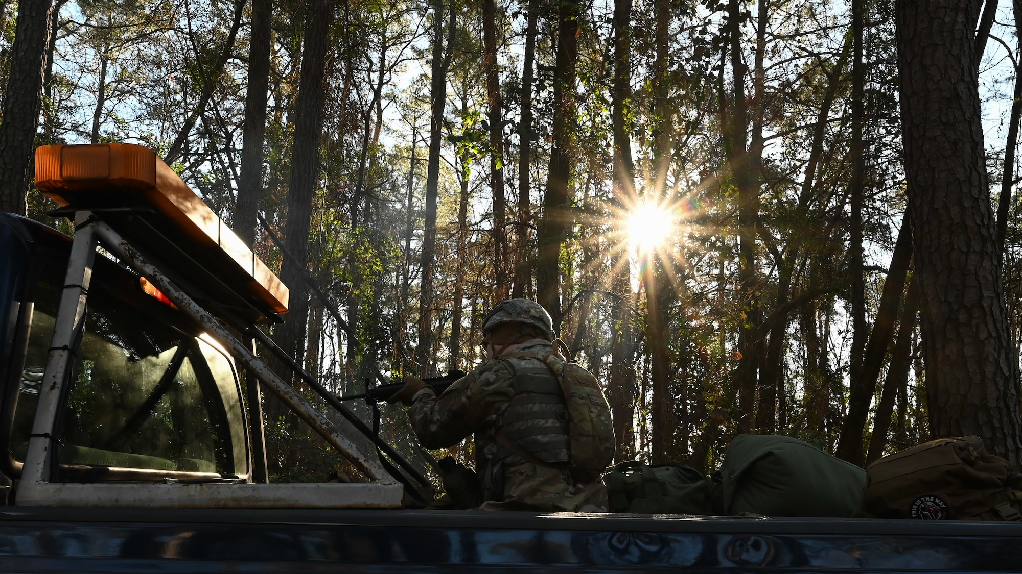 A U.S. Airman assigned to the 4th Civil Engineer Squadron aim an M4 carbine during a bivouac training exercise at Seymour Johnson Air Force Base, North Carolina, Jan. 18, 2024. Over the course of the exercise, participants practiced building defensive fighting positions, responded to vehicle checkpoints, and performed post-attack reconnaissance sweeps , while demonstrating their ability to survive and operate in a hostile environment. (U.S. Air Force Photo by Airman Rebecca Tierney)