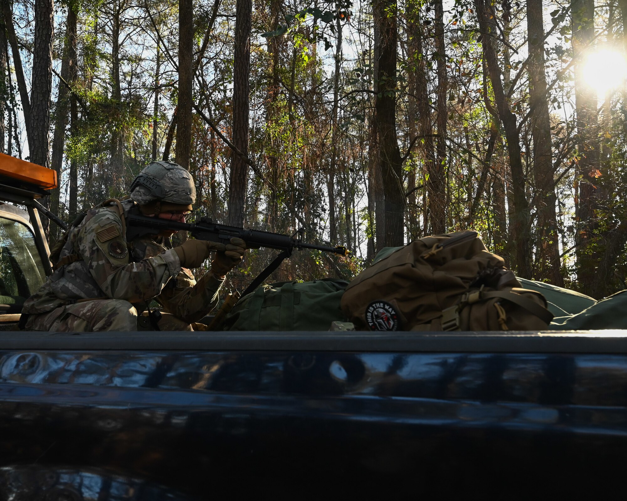 A U.S. Airman assigned to the 4th Civil Engineer Squadron aims an M4 carbine during a bivouac training exercise at Seymour Johnson Air Force Base, North Carolina, Jan. 18, 2024. The bivouac training tested the squadron's ability to secure and establish base operations infrastructure within a timely manner and conduct contingency and wartime operations if the opportunity were to arise. (U.S. Air Force Photo by Airman Rebecca Tierney)