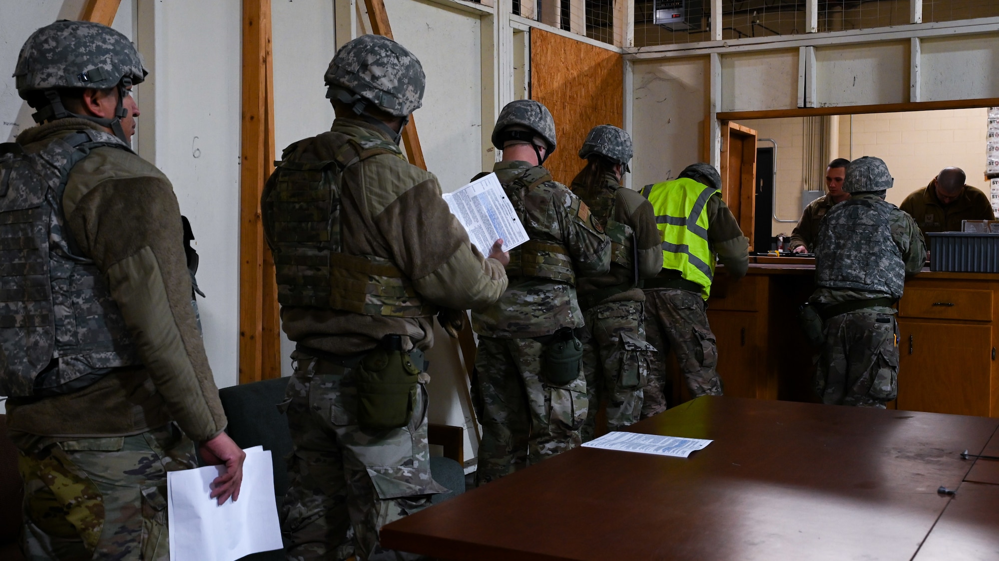 U.S. Airmen assigned to the 4th Civil Engineer Squadron are issued weapons for a bivouac field training exercise at Seymour Johnson Air Force Base, North Carolina, Jan. 18, 2024. The bivouac training tested the squadron's ability to secure and establish base operations infrastructure within a timely manner and conduct contingency and wartime operations if the opportunity were to arise. (U.S. Air Force Photo by Airman Rebecca Tierney)