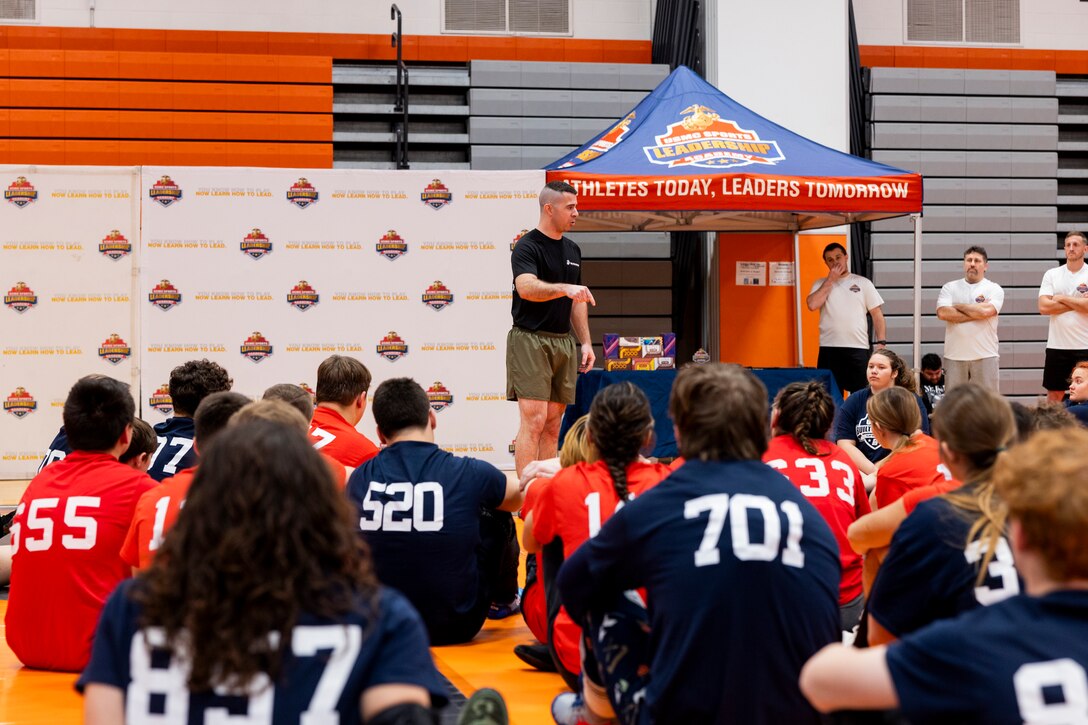 U.S. Marine Corps Capt. Jay Ringenbach, a recruiting support officer with Recruiting Station Albany, gives opening remarks during a wrestling clinic with the United States Marine Corps Sports Leadership Academy (USMC SLA) at John C Birdlebough High School, Phoenix, New York, Nov, 11, 2023