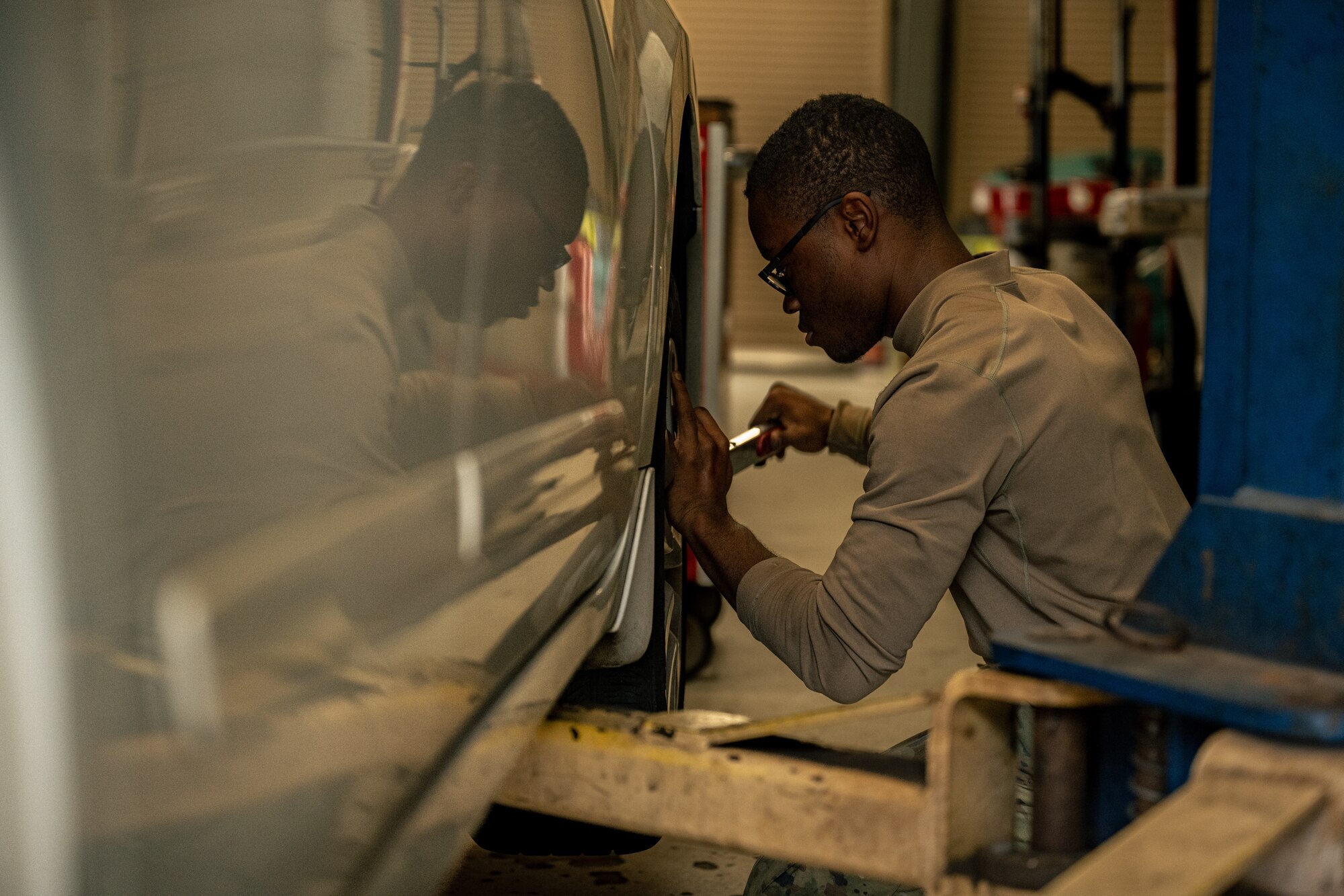 U.S. Air Force Senior Airman Zaire Pitts, a 4th Aircraft Maintenance Unit crew chief, uses a torque wrench to replace lug nuts on a wheel at the Auto Hobby Shop.