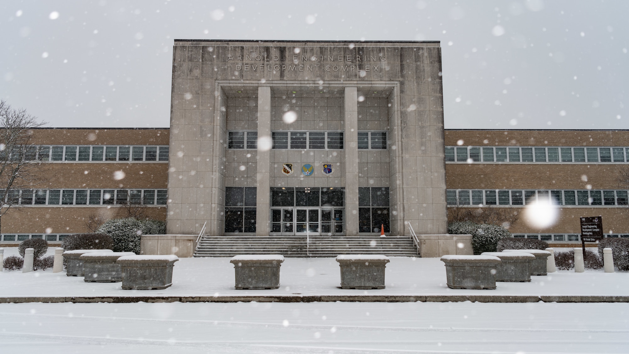 Snow accumulates at the Administration and Engineering building, located at Arnold Air Force Base, Tenn., Jan. 15, 2024. The area saw snow accumulations of several inches as a winter storm moved across Middle Tennessee bringing heavy snowfall and frigid temperatures. (U.S. Air Force photo by Keith Thornburgh)