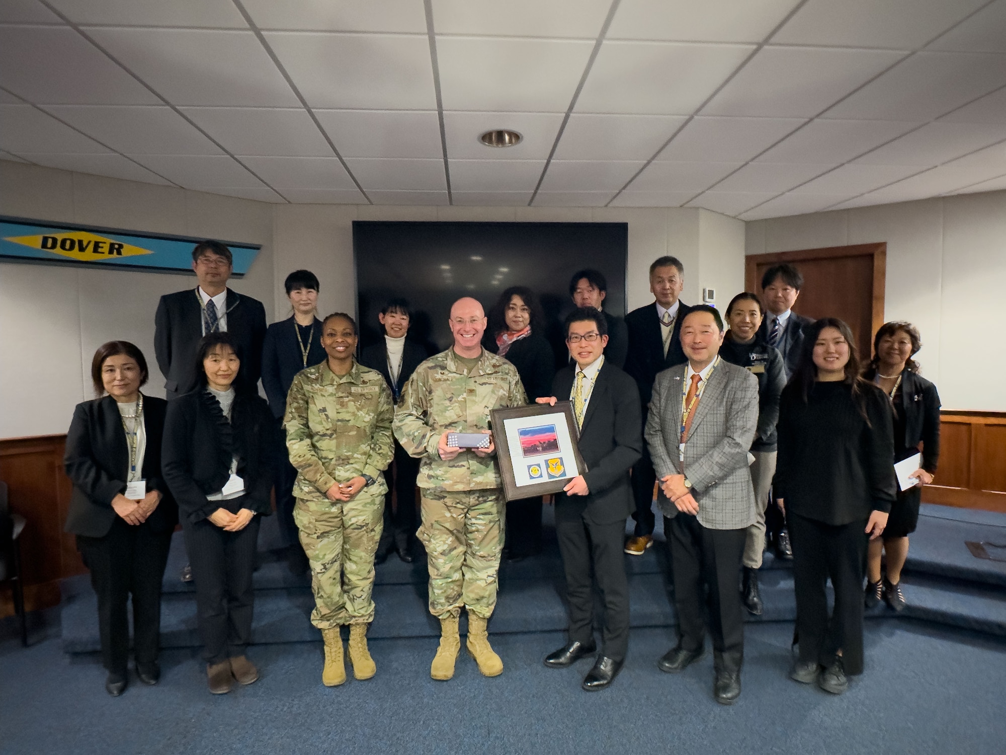 U.S. Air Force Col. Chris McDonald, 436th Airlift Wing commander, and U.S. Air Force Chief Master Sgt. Carolyn Russell, 436th Airlift Wing command chief, poses with members of the Miyagi Prefecture delegation from Japan, at Dover Air Force Base, Delaware, Jan. 23, 2024. The delegation met with 436th Airlift Wing leadership to embody the growing bond between the “sister cities.” (U.S. Air Force photo by Zachary Cacicia)
