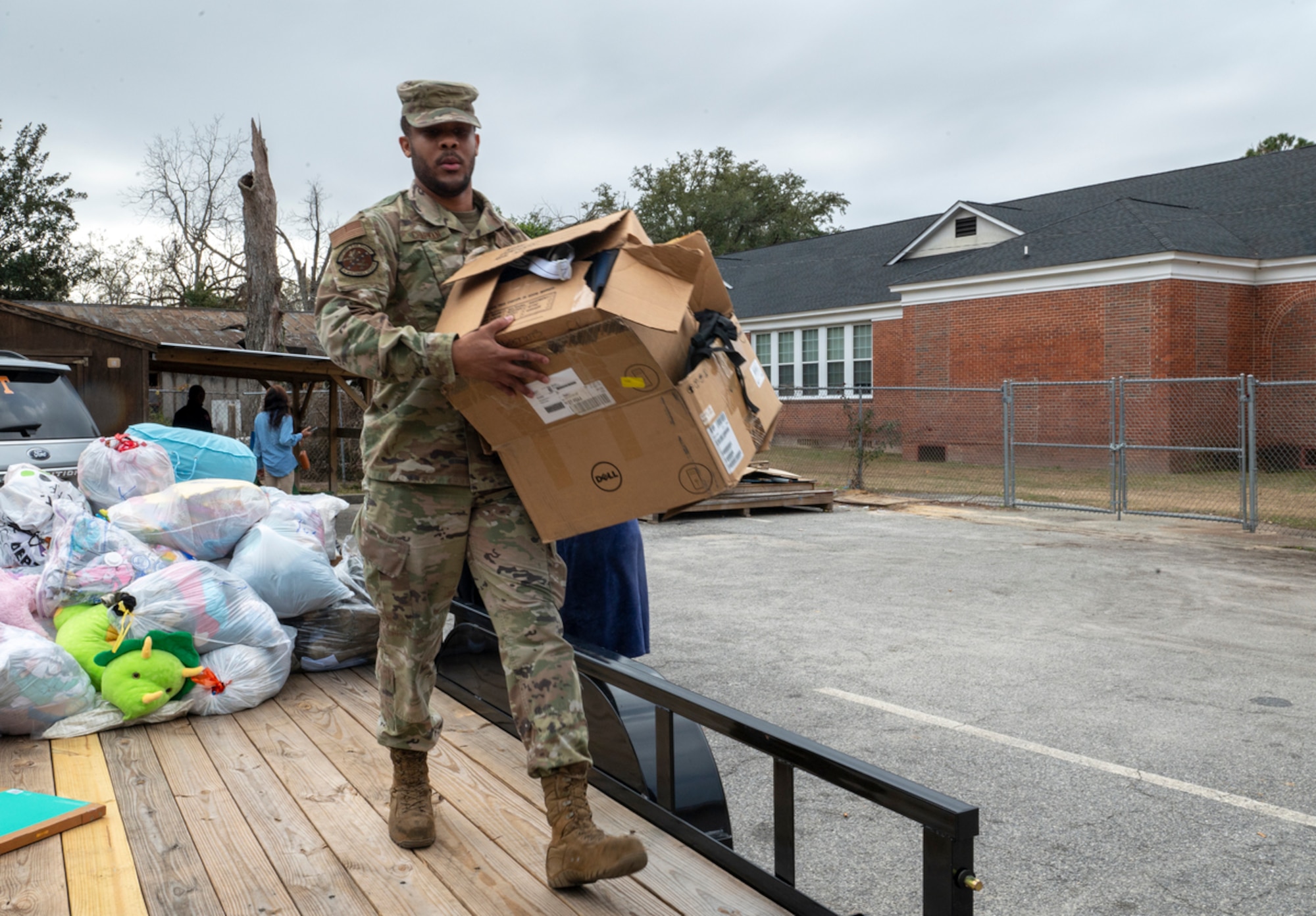 U.S. Air Force Senior Airman Anthony Chapman, 23rd Maintenance Group aircraft fuel systems repair technician, carries a box of donations in Valdosta, Georgia, Jan. 18, 2024. Household goods, toys, strollers, clothes and other items were donated to a local nonprofit to help those in need. (U.S. Air Force photo by Airman 1st Class Leonid Soubbotine)