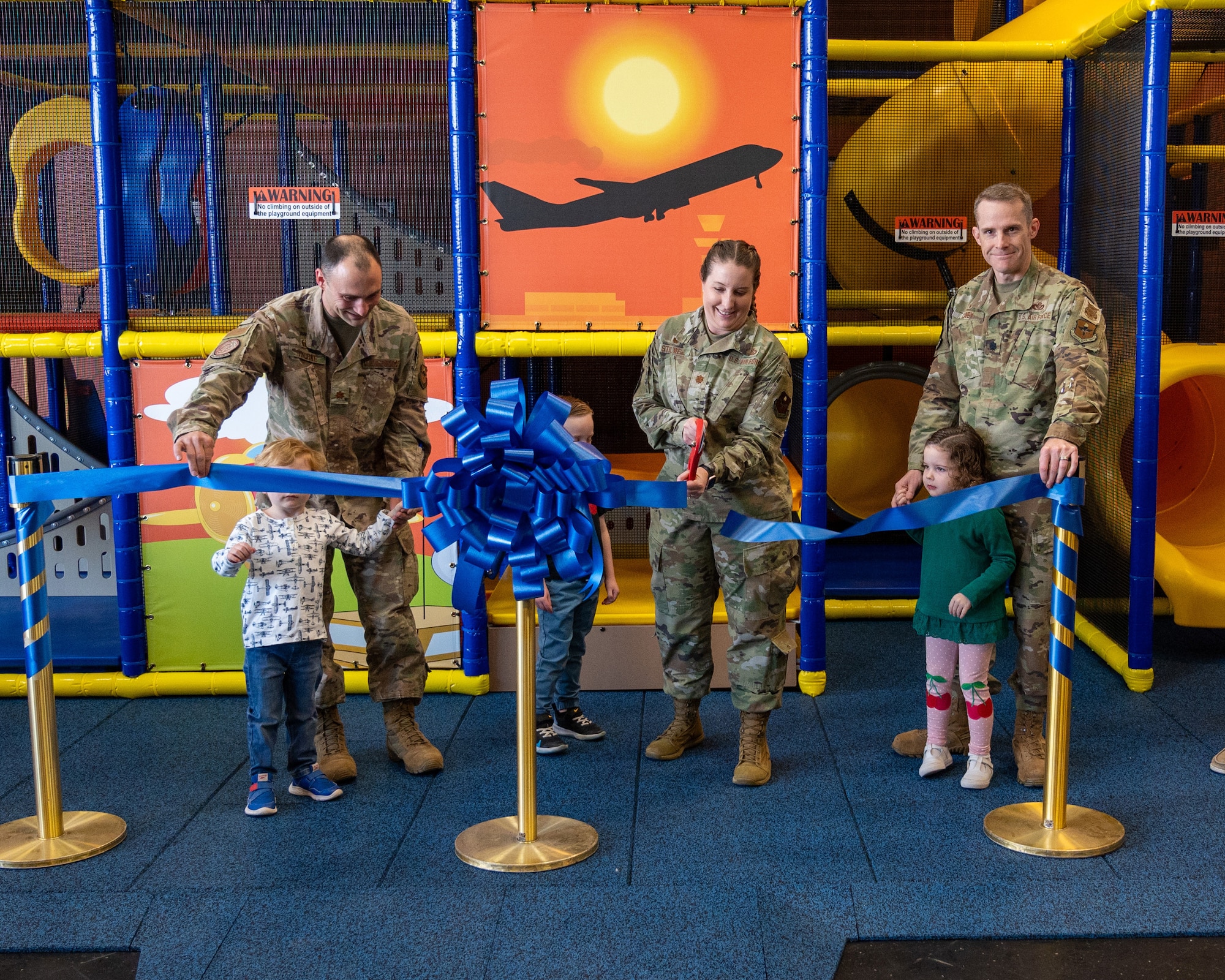 U.S. Air Force Maj. Matthew Thorne (left), 47th Contracting Squadron commander, Maj. Kayleigh Stilwell (center), 47th Force Support Squadron (FSS) commander, and Lt. Col. John Casey (right), 47th Civil Engineer Squadron commander, officially open the indoor playground at the Losano Fitness Center at Laughlin Air Force Base, Texas, Jan. 20, 2024. The new indoor playground offers a climate-controlled area for children to play during the summer months where temperatures can reach 100+ degrees for weeks at a time. Fitness is an important part of the 47th Flying Training Wing’s priorities, allowing for easier access for parents and improving the quality of life for Airmen exercising promotes physical readiness. (U.S. Air Force photo by Staff Sgt. Nicholas Larsen)