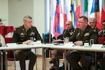 Army Maj. Gen. Gregory Knight, Vermont's adjutant general, right, and Army Gen. Daniel Hokanson, chief, National Guard Bureau, speak with joint Austrian Armed Forces leaders, at the Federal Ministry of Defence of Austria in Vienna