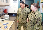 JOINT BASE SAN ANTONIO-FORT SAM HOUSTON – (Jan. 24, 2024) – Hospital Corpsman 2nd Class Amber Rimes, of Dubuque, Iowa, a dental laboratory instructor assigned to Navy Medicine Training Support Center (NMTSC), gives a tour of facilities at the Defense Health Agency’s (DHA) Medical Training and Education Campus (METC) to Force Master Chief PatrickPaul Mangaran, director, Hospital Corps, U.S. Navy Bureau of Medicine and Surgery (BUMED). METC is a leader in military medical education with over 48 academic programs in various medical specialties. With 48 medical programs, and 16,500 graduates a year, METC is a state-of-the-art Department of Defense (DoD) healthcare education campus that trains enlisted medical personnel. (U.S. Navy photo by Burrell Parmer, NMFSC Public Affairs/Released)