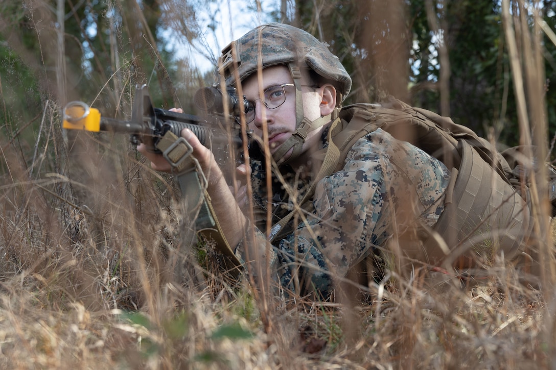 U.S. Marine Corps Cpl. Ethan Dotson, a Midland, Michigan native and french horn instrumentalist with the 2d Marine Division Band, posts security at an Infantry Immersion Trainer (ITT) on Camp Lejeune, North Carolina, Jan. 19, 2024. The IIT is used to fully immerse Marines in various scenarios in order to teach them to effectively adapt to complete combat, security, and humanitarian missions. (U.S. Marine Corps photo by Lance Cpl. Tahir Noel)