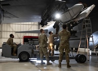 Airmen assigned to the 5th Aircraft Maintenance Squadron load an inert AGM-158 Joint Air to Surface Standoff Missile (JASSM) onto a B-52H Stratofortress during the 2024 annual weapons load competition at Minot Air Force Base, North Dakota, Jan. 19, 2024. These Airmen were tasked to load the JASSM onto a B-52H Stratofortress as fast and efficiently as possible while also maintaining all safety precautions.