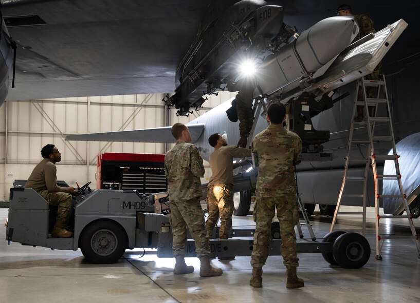 Airmen assigned to the 5th Aircraft Maintenance Squadron load an inert AGM-158 Joint Air to Surface Standoff Missile (JASSM) onto a B-52H Stratofortress during the 2024 annual weapons load competition at Minot Air Force Base, North Dakota, Jan. 19, 2024. These Airmen were tasked to load the JASSM onto a B-52H Stratofortress as fast and efficiently as possible while also maintaining all safety precautions.