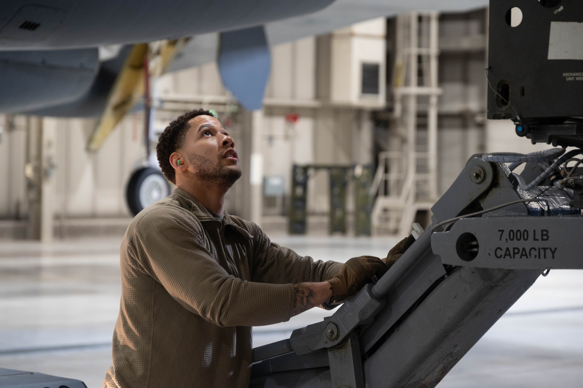 Senior Airman Dillon Carrington, 5th Aircraft Maintenance Squadron load crew member, assists his team in raising an inert AGM-158 Joint Air to Surface Standoff Missile (JASSM) onto a B-52H Stratofortress as part of the 2024 annual weapons load competition at Minot Air Force Base, North Dakota, Jan. 19, 2024. These competitions not only showcase the skills and teamwork of these crews, but also play a significant role in enhancing mission readiness and strengthening Global Strike capabilities.