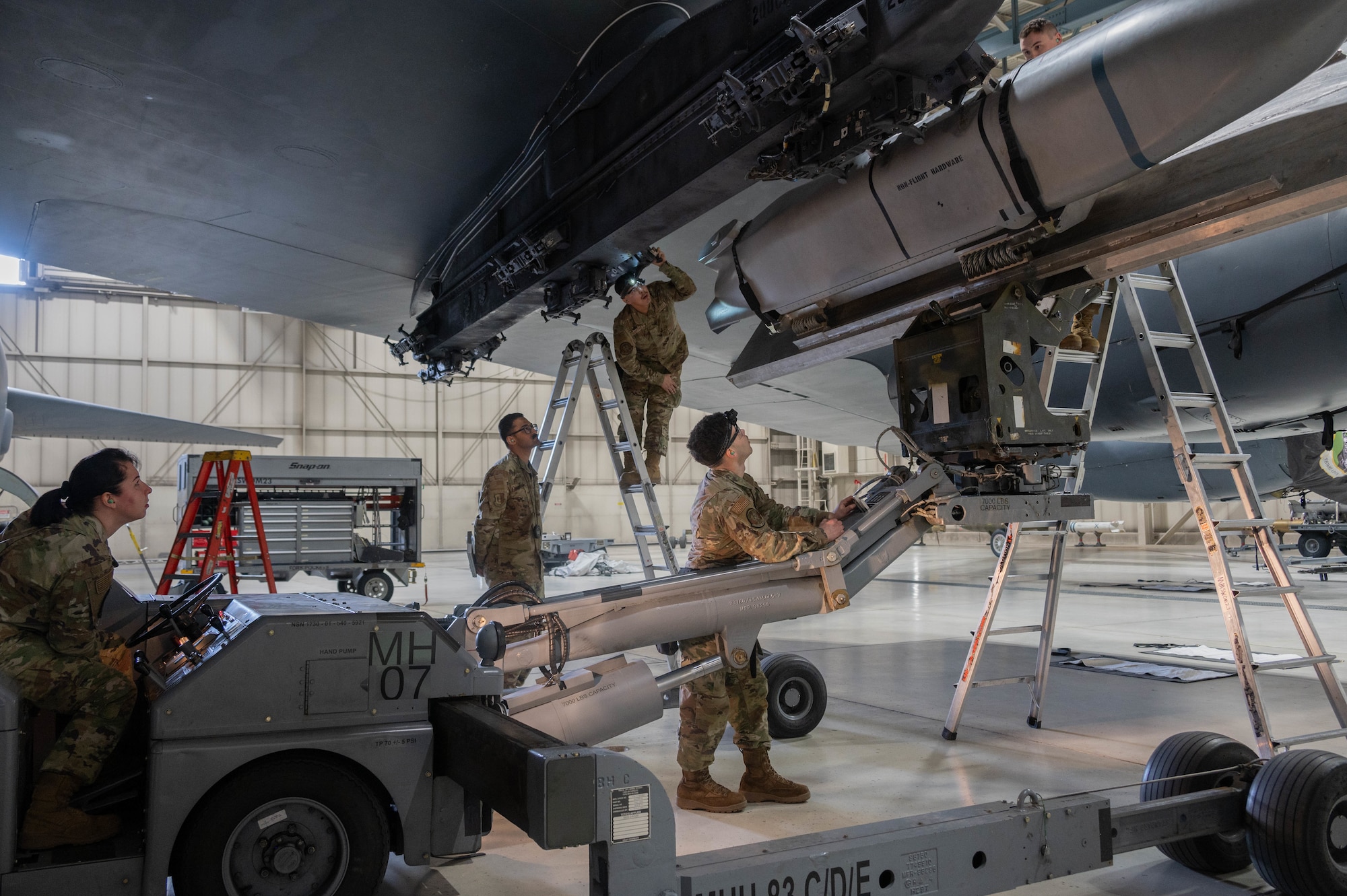 Members of the 5th Aircraft Maintenance Squadron load an inert AGM-158 Joint Air to Surface Standoff Missile (JASSM) onto a B-52H Stratofortress as part of the 2024 annual weapons load competition at Minot Air Force Base, North Dakota, Jan. 19, 2024. Airmen loaded an inert AGM-158 JASSM onto a B-52H Stratofortress as quickly as possible while maintaining all safety precautions.