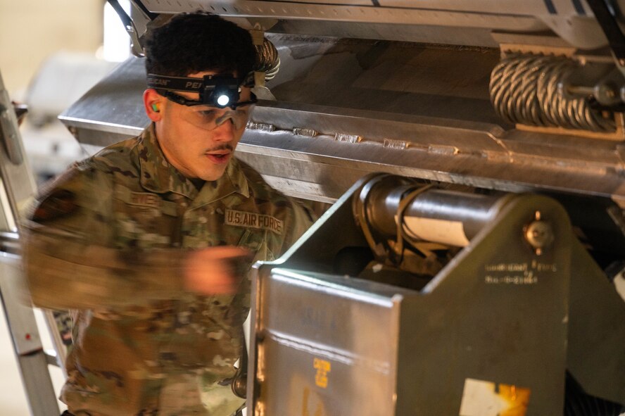 Senior Airman Benjamin Rivera, 5th Aircraft Maintenance Squadron load crew member, loads an inert AGM-158 Joint Air to Surface Standoff Missile (JASSM) onto a B-52H Stratofortress during the 2024 annual weapons load competition at Minot Air Force Base, North Dakota, Jan. 19, 2024. Rivera’s team was judged on how quickly and efficiently they could and load an inert missile onto a B-52H Stratofortress.