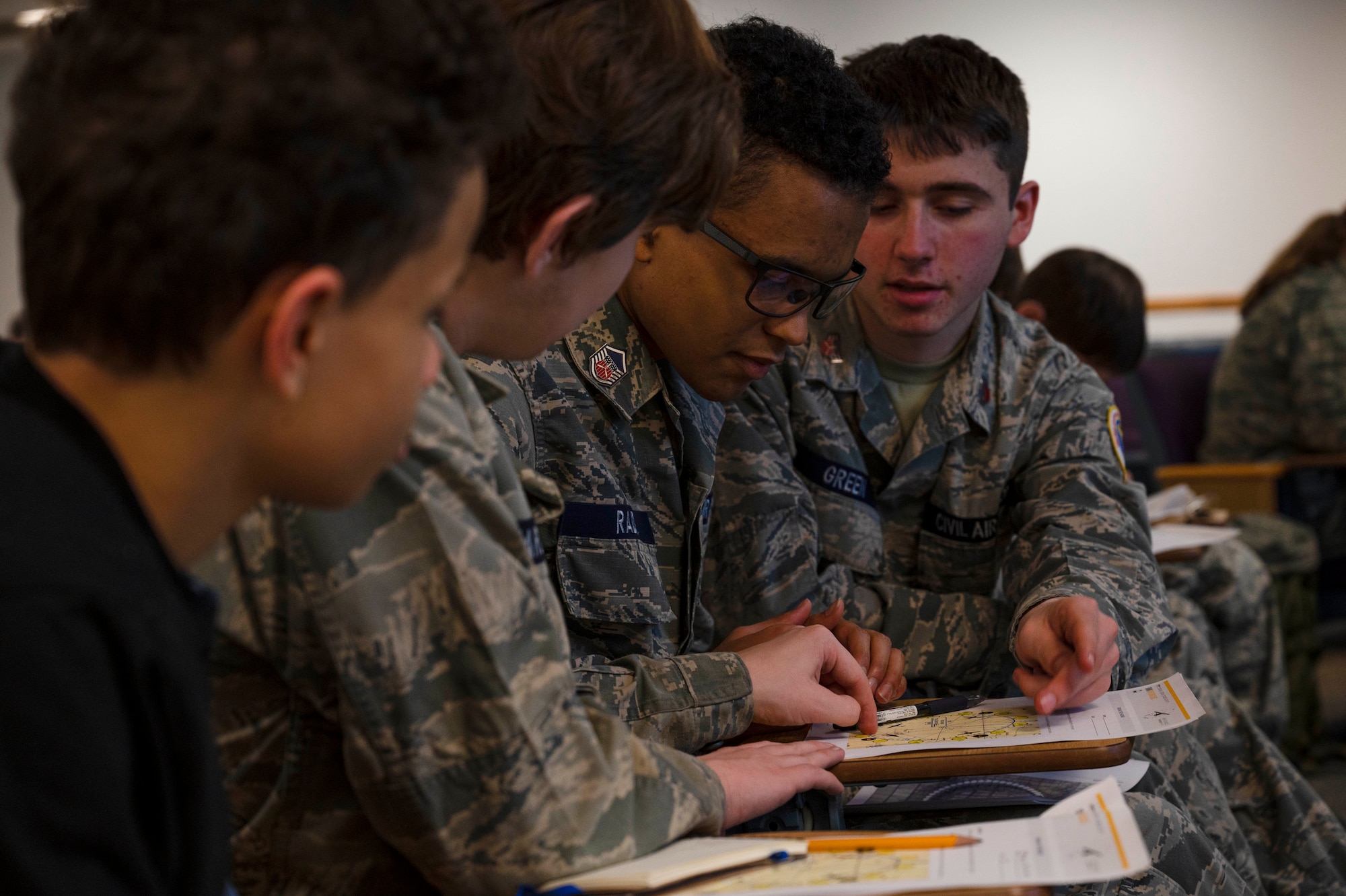 Mississippi Civil Air Patrol Colonel Berta A. Edge Composite Squadron cadets work together to complete an aerospace lesson worksheet during a CAP meeting on Keesler Air Force Base, Mississippi, Jan. 9, 2024.