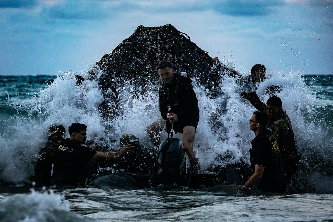 U.S. Marines with 1st, 2nd, and 3rd Radio Battalion conduct a surf passage training event during a Radio Reconnaissance Operator Course, Marine Corps Training Area Bellows, Marine Corps Base Hawaii, May 2, 2019. The course aimed to maintain the units' combat readiness and effectiveness, along with increasing cohesion between the three battalions.