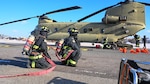 First responders conduct a pre-accident drill upon a Chinook on Desiderio Army Airfield, Jan. 23, 2024 on U.S. Army Garrison Humphreys. The installation conducts the drill on a regular basis and tests rescue and recovery operations.(U.S. Army photo by Pfc. Johnny Rodriguez.)