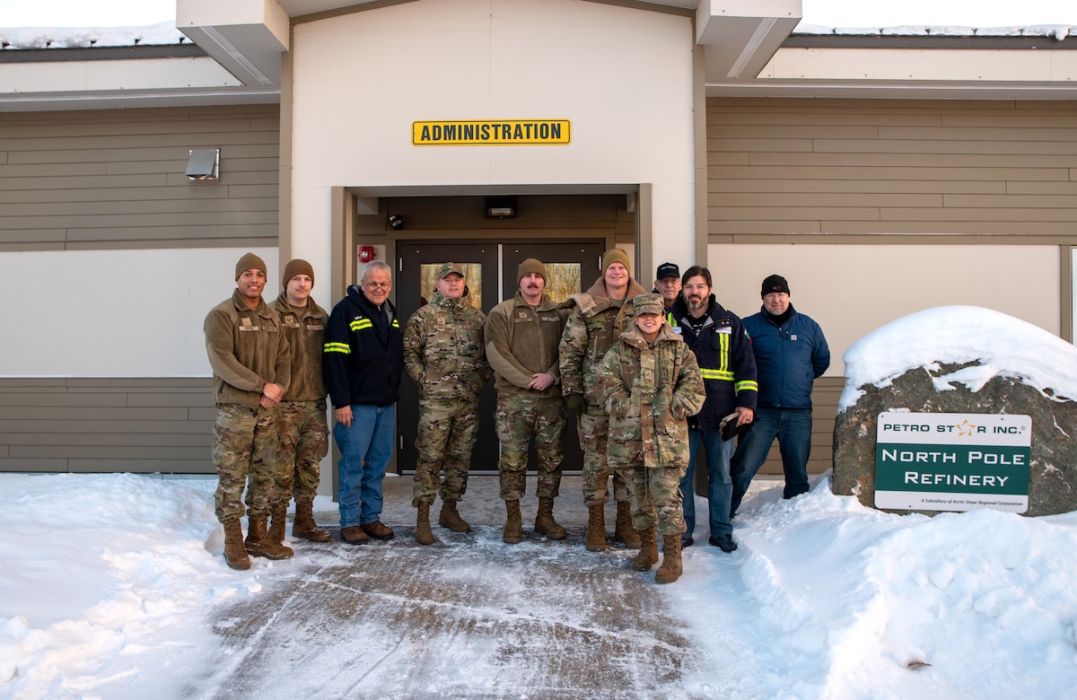 Petro Star Inc. employees, 354th Logistics Readiness Squadron Airmen, and 354th Fighter Wing leadership pose for a photo at the Petro Star Inc. Oil Refinery, North Pole, Alaska, on Jan. 22, 2024.