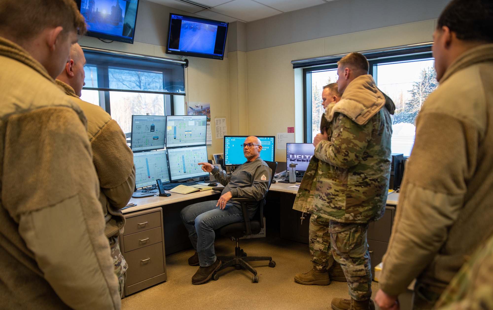Shayne O'Conner, Petro Star Inc. employee, briefs Airmen assigned to the 354th Fighter Wing at the Petro Star Inc. Oil Refinery, North Pole, Alaska, on Jan. 22, 2024.
