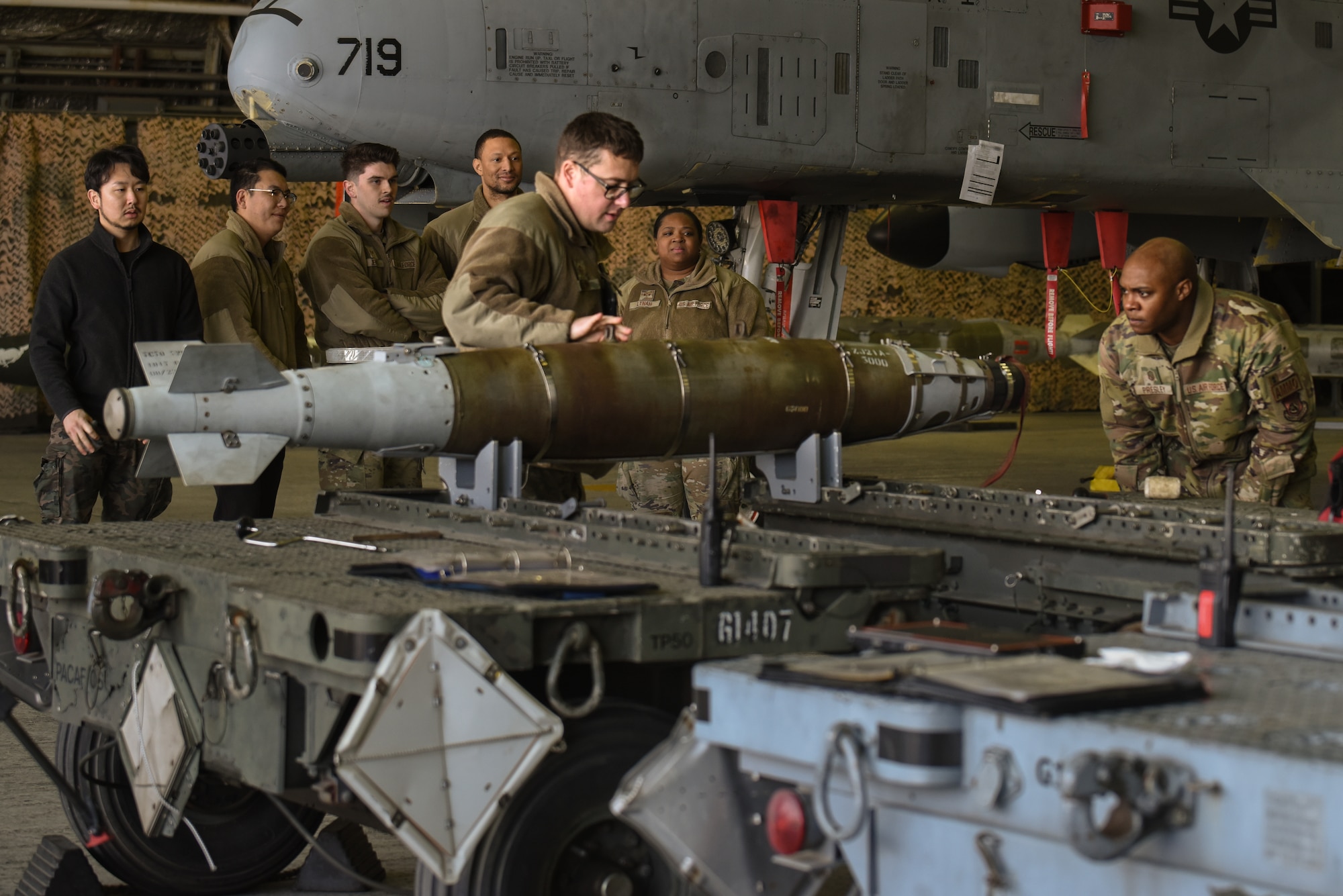 Evaluators from the 51st Munitions Squadron inspect a GBU-54 for technical accuracy during the annual Load Crew Competition at Osan Air Base, Republic of Korea, Jan. 19, 2024. As part of the process to determine the winning group, inspections are conducted to ensure technical accuracy. These competitions refine Airmen’s skills and problem-solving capabilities, ensuring they are at the top of their game when executing their mission. (U.S. Air Force photo by Senior Airman Brittany Russell)