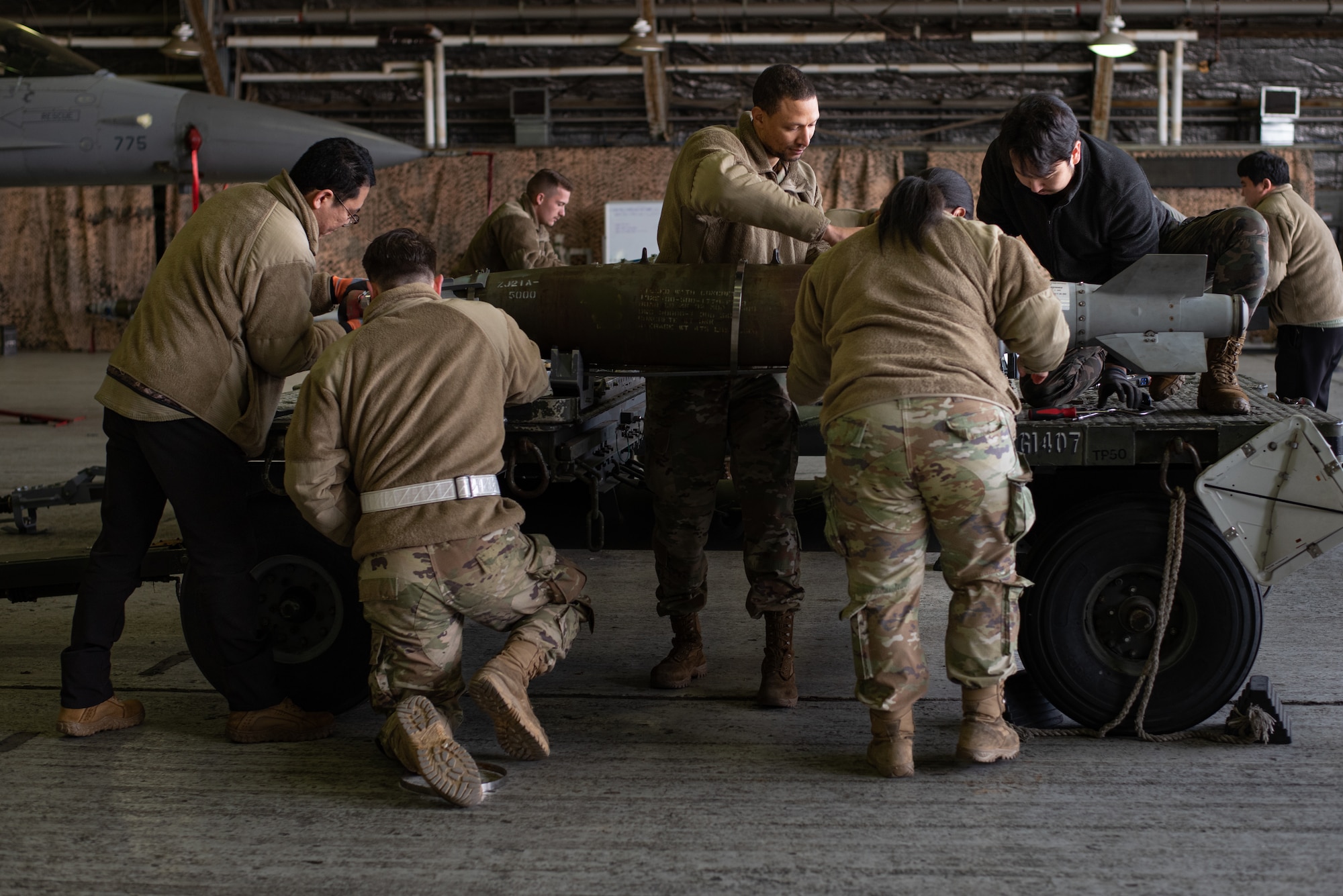 Members from the 51st Munitions Squadron participate in the annual Load Crew Competition at Osan Air Base, Republic of Korea, Jan. 19, 2024. During the competition, conventional maintenance technicians are graded on their speed and technical accuracy. This fosters a challenging and controlled environment that enables Airmen to enhance their skills, ensuring they are executing the mission to the best of their ability. (U.S. Air Force photo by Senior Airman Brittany Russell)