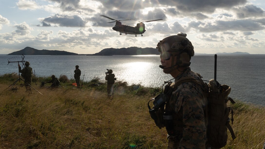 U.S. Marine Corps Capt. Eric Pak, a forward air controller officer with 5th Air Naval Gunfire Liaison Company, III Marine Expeditionary Force Information Group, observes the landing zone of a Japan Ground Self-Defense Force CH-47J Chinook during joint terminal attack controller training at Irisuna Island, Okinawa, Japan, Nov. 15, 2023. The training tested U.S. and Japanese service members’ ability to enhance and sustain tactics and procedures for terminal control of fires. 5th ANGLICO provides the Marine Air Ground Task Force Commander with a liaison capability to plan, coordinate, employ, and conduct terminal control of fires in support of joint, allied, and coalition forces. Pak is a native of Los Angeles. (U.S. Marine Corps photo by Cpl. William Wallace)