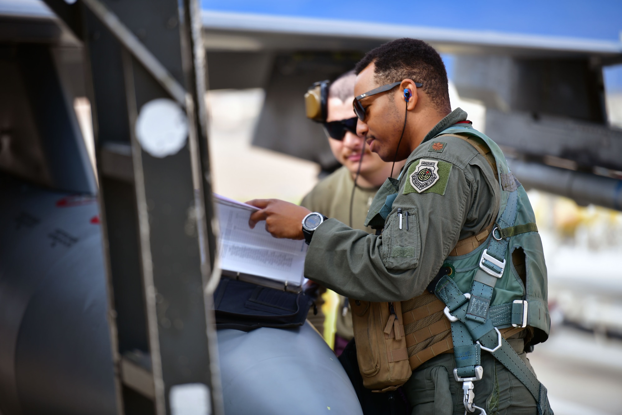 crew chief and pilot talking on flight line