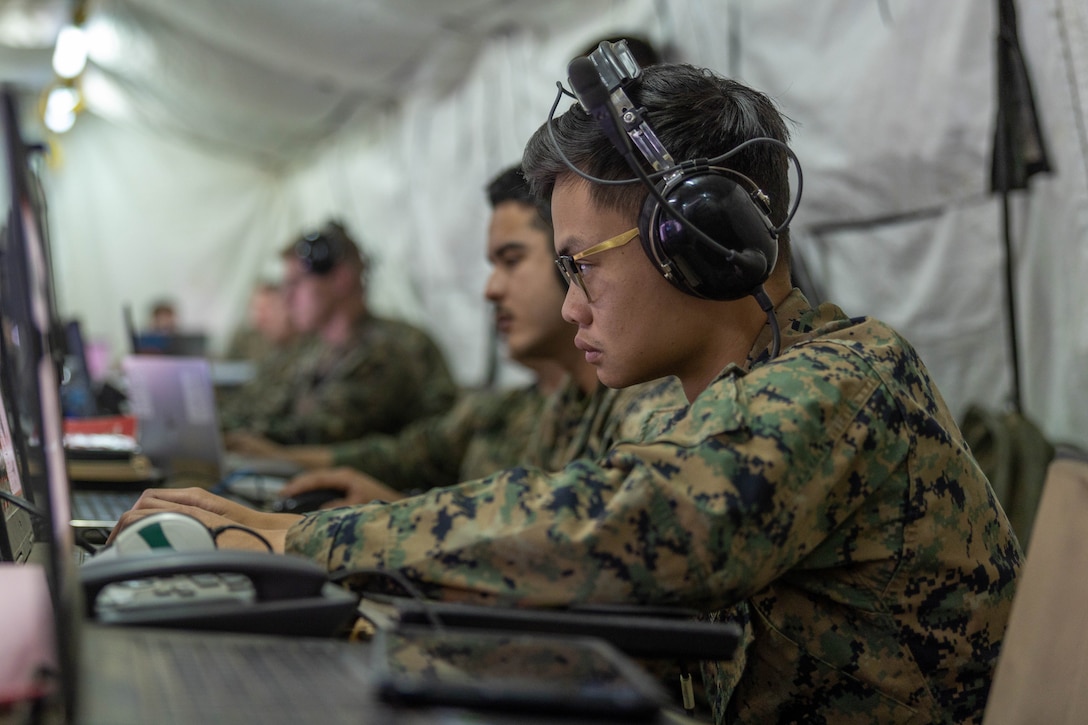 U.S. Marine Corps Cpl. Johnson Truong, an air support operations operator with Marine Air Support Squadron 3, Marine Air Control Group 38, 3rd Marine Aircraft Wing, coordinates fire missions from the Multifunction Air Operations Center in support of Exercise Steel Knight 23.2 at Marine Corps Base Camp Pendleton, California, Dec. 6, 2023. The MAOC provides expeditionary aviation command and control and air surveillance to the Marine Air-Ground Task Force. Steel Knight 23.2 is a three-phase exercise designed to train I Marine Expeditionary Force in the planning, deployment and command and control of a joint force against a peer or near-peer adversary combat force and enhance existing live-fire and maneuver capabilities of the MAGTF. (U.S. Marine Corps photo by Cpl. Daniel Childs)
