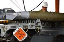 person building bomb with explosives labeled