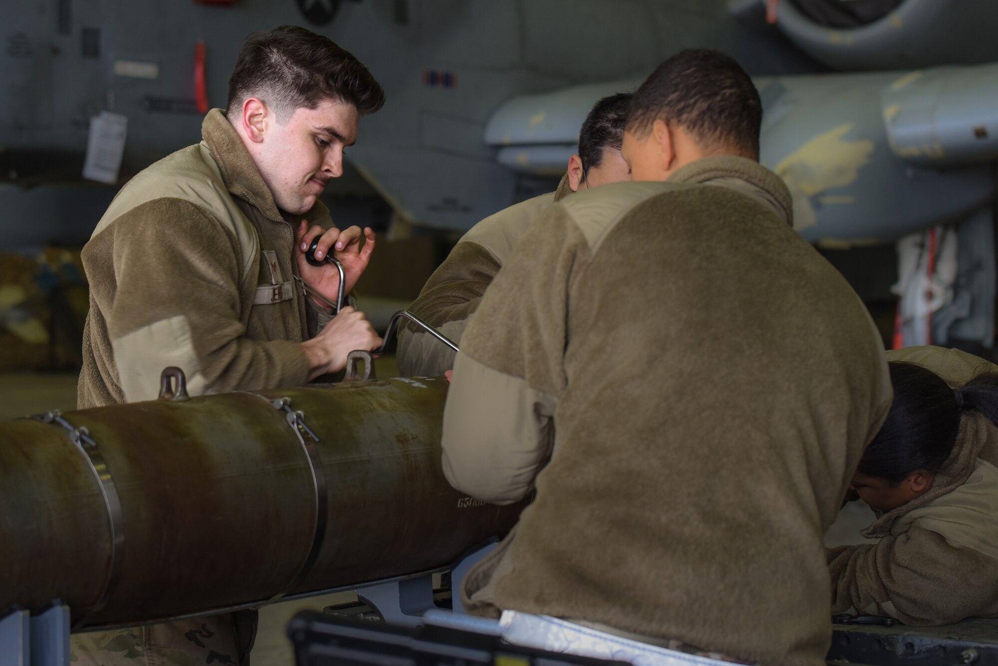 U.S. Airmen from the 51st Munitions Squadron participate in the annual Load Crew Competition at Osan Air Base, Republic of Korea, Jan. 19, 2024. During the competition, conventional maintenance technicians must disassemble and reassemble munitions and are judged on speed and technical accuracy. This annual competition enhances preparedness and ensures effective responses to potential contingencies. (U.S. Air Force photo by Senior Airman Brittany Russell)