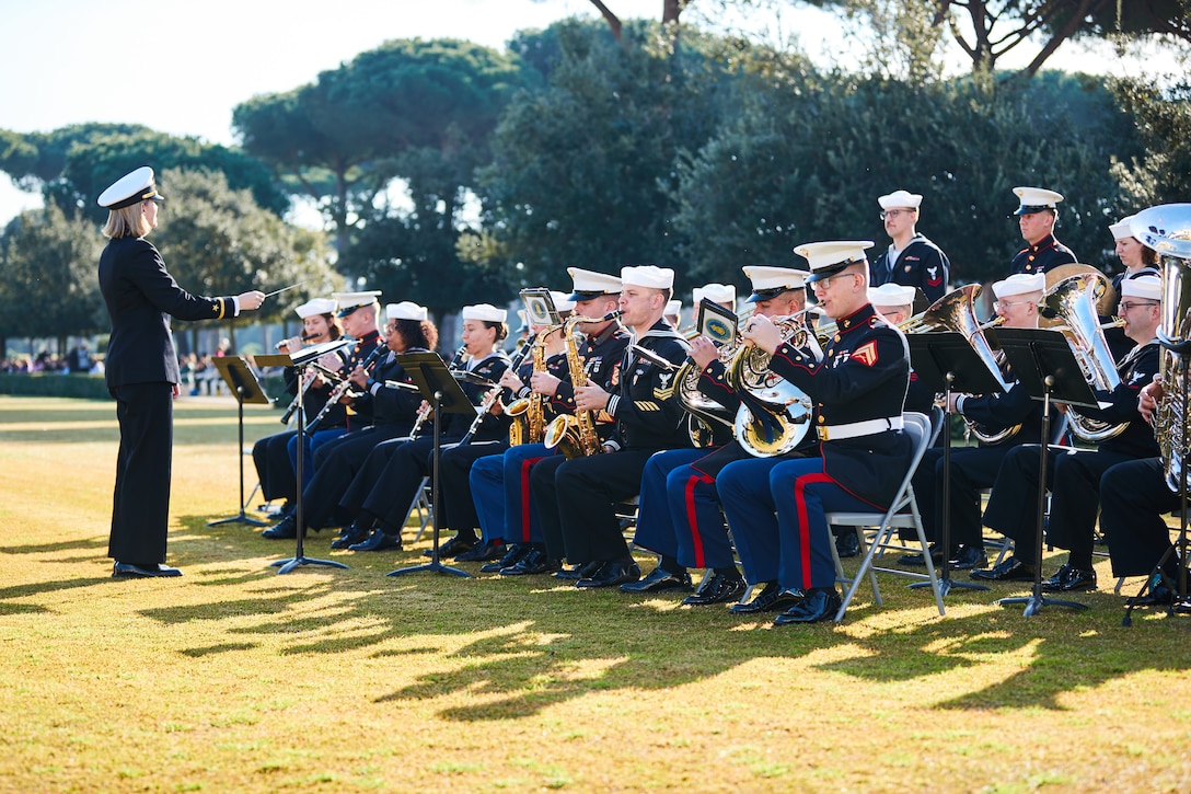 U.S. Marines and Sailors with the Naval Forces Europe and Africa Band perform during the 80th anniversary of the Allied landings at Anzio and Nettuno in Nettuno, Italy, on Jan. 24, 2024. The Sicily-Rome American Cemetery hosted the ceremony to commemorate Operation Shingle, the codename for the Allied landings at Anzio and Nettuno. The ceremony honored the service members who fought and died in the vicinity during World War II. (U.S. Marine Corps photo by Lance Cpl. Maxwell Cook)
