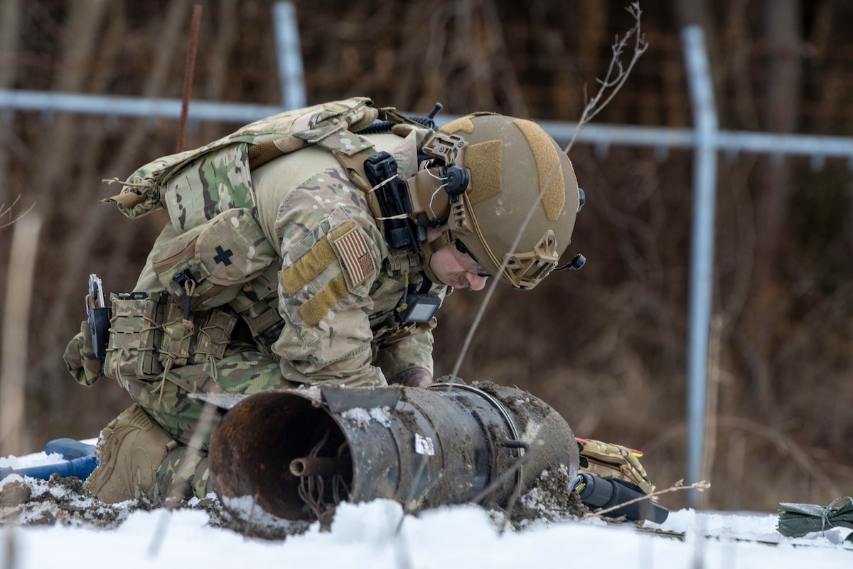 A U.S. Air Force Explosive Ordnance Disposal (EOD) technician thoroughly examines a training Unexploded Ordnance (UXO) before discerning how to best remove it during the HABU exercise at Misawa Air Base, Japan, Jan. 23, 2024.