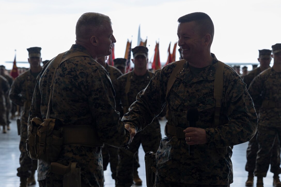 U.S. Marine Corps Lt. Gen. James W. Bierman, the offgoing III Marine Expeditionary Force Commanding General, shakes hands with Lt. Gen. Roger Turner during the III MEF change of command ceremony on Marine Corps Air Station Futenma, Okinawa, Japan, Jan. 26, 2024. During the ceremony, Bierman relinquished his duties as commanding general of III MEF to Turner. (U.S. Marine Corps photo by Sgt. Savannah Mesimer)