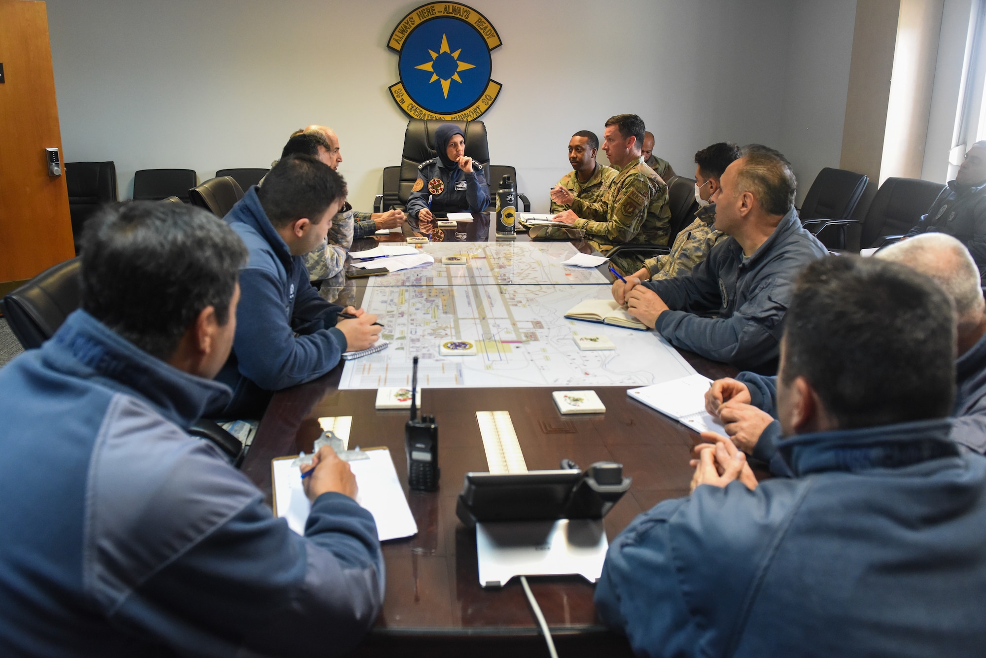 Turkish and American military members in an office meeting